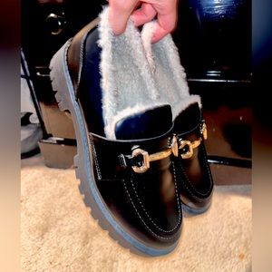 Black loafers with gold buckle